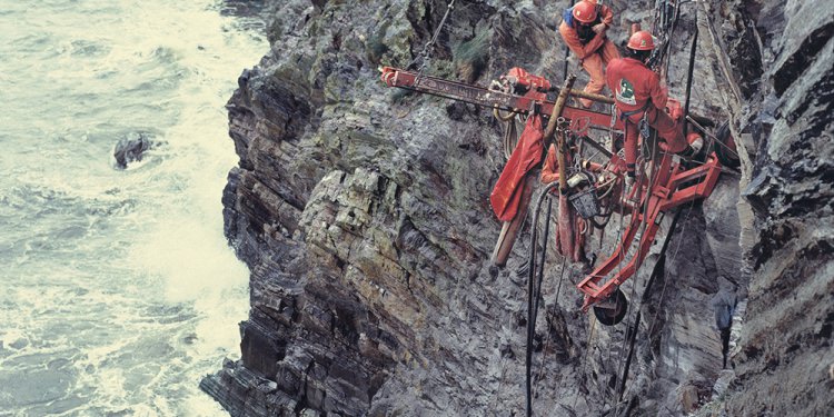 Workers on the side of a cliff