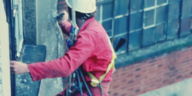 Workers on the side of a building
