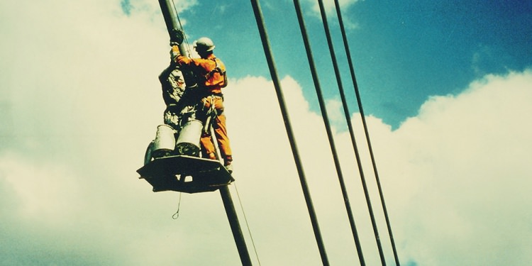 Workers on a suspension cable.
