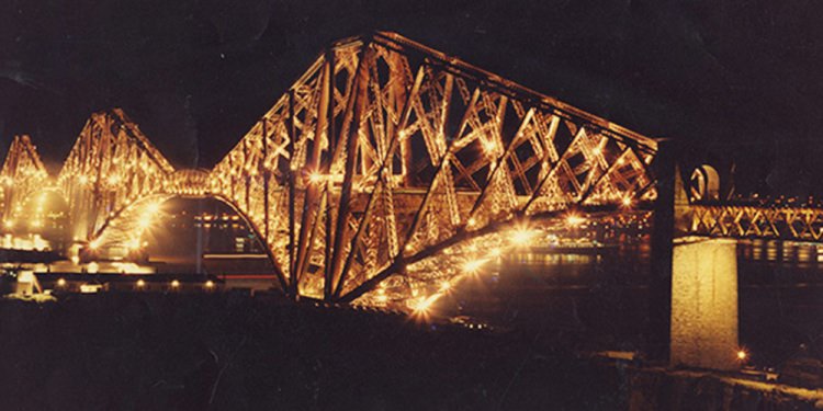 Fort rail bridge lit up at night