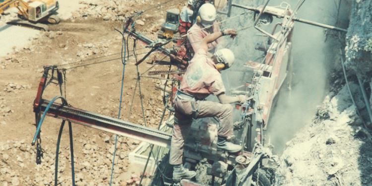Workers covered in dust